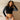 Front view with standing model of Iron Imperium “Embody It” women’s recycled long-sleeve crop top with Iron Imperium logo